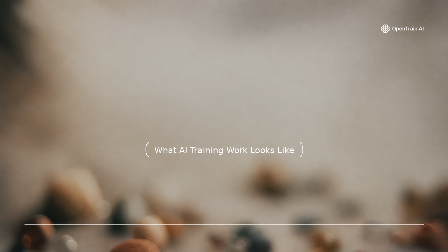 Abstract editorial blog cover: a softly blurred, shallow-focus close-up of small stones and glass beads scattered on a muted surface in clay, terracotta, steel-grey, and sand tones with a single small blue bead, under a centered title, a divider line, and the OpenTrain wordmark.