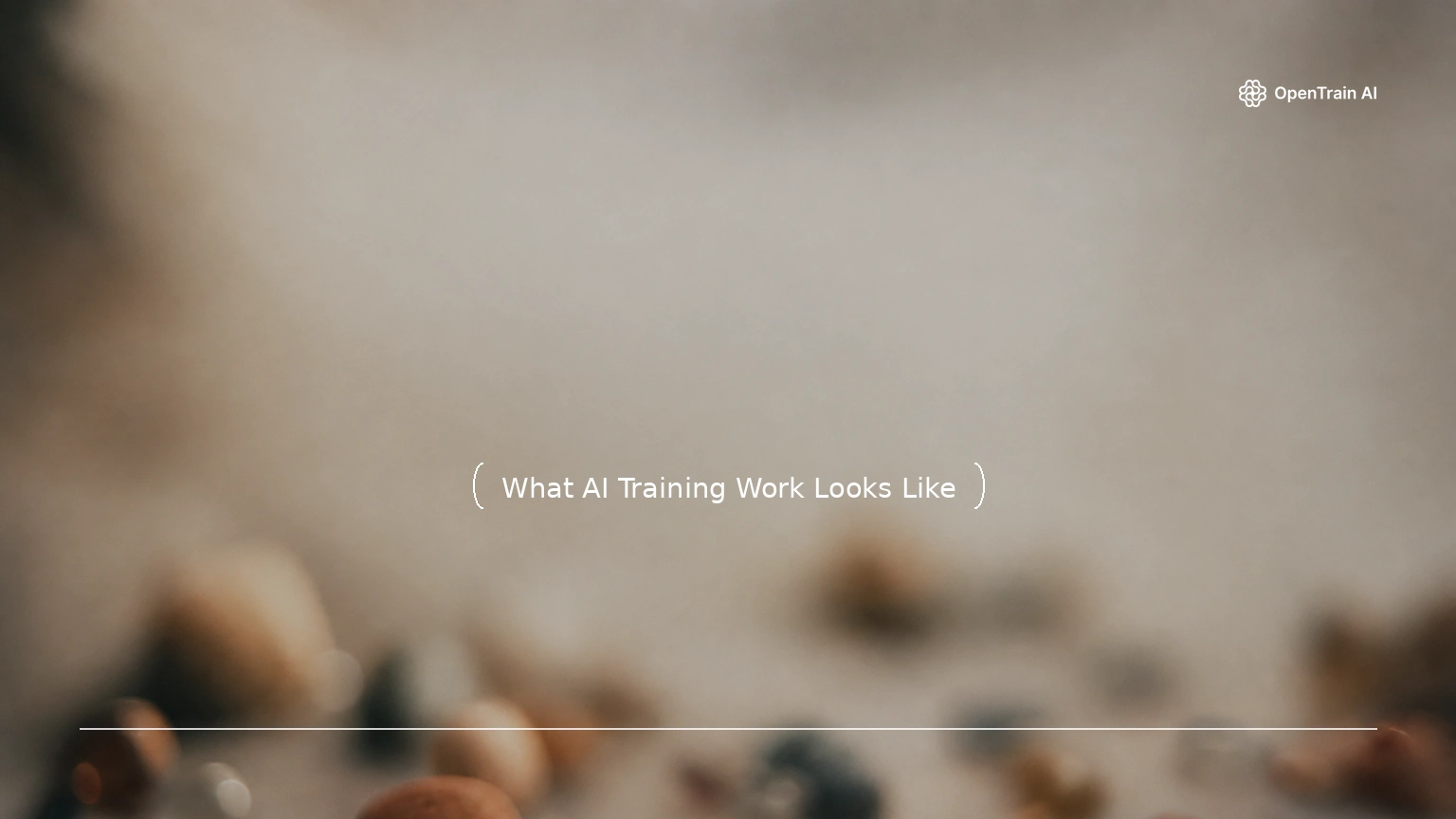 Abstract editorial blog cover: a softly blurred, shallow-focus close-up of small stones and glass beads scattered on a muted surface in clay, terracotta, steel-grey, and sand tones with a single small blue bead, under a centered title, a divider line, and the OpenTrain wordmark.